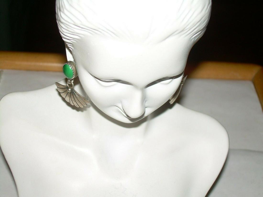 Vintage Southwest Sterling Dangling Earrings -Malachite: Vintage sterling silver southwestern stud pierced earrings. The earrings have a malachite stone where the stud is. The stone is in a saw tooth setting. There is a silver fan dangling from the stud. Th