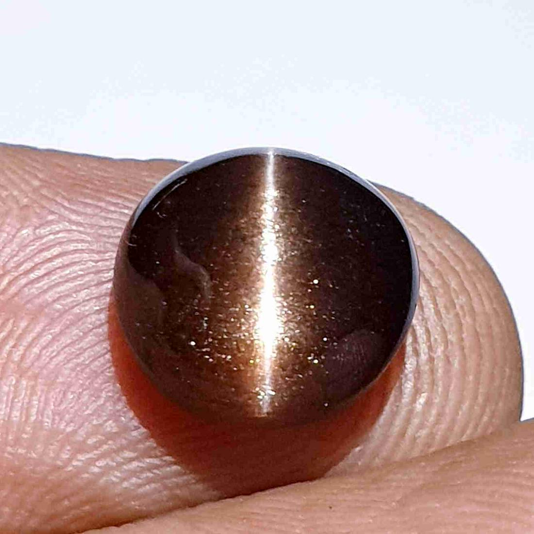 Natural Scapolite Cat's Eye 5.00 ct: No Reserve! Title: Natural Scapolite Cat's Eye 5.00 ct Color/Clarity: Opaque Gemstones: Loosegemstone Carat Weights: 5 Size/Dimensions: 10.50 x 10.20 x 6.20 Additional Information: Round - Africa Ship
