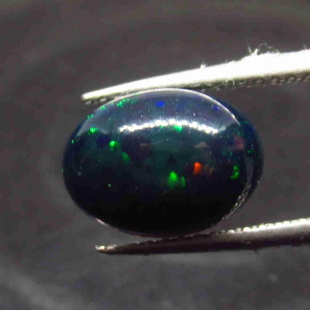 1.95 Ctw Natural Ethiopian Black Fire Opal Oval Cab: No Reserve! Title: 1.95 Ctw Natural Ethiopian Black Fire Opal Oval Cab Stone Clarity: Translucent Gemstone: Natural Black Opal Carat Weight: 1.95 Size/Dimensions: 11.80 x 7.90 x 4.80 mm Additional Inf