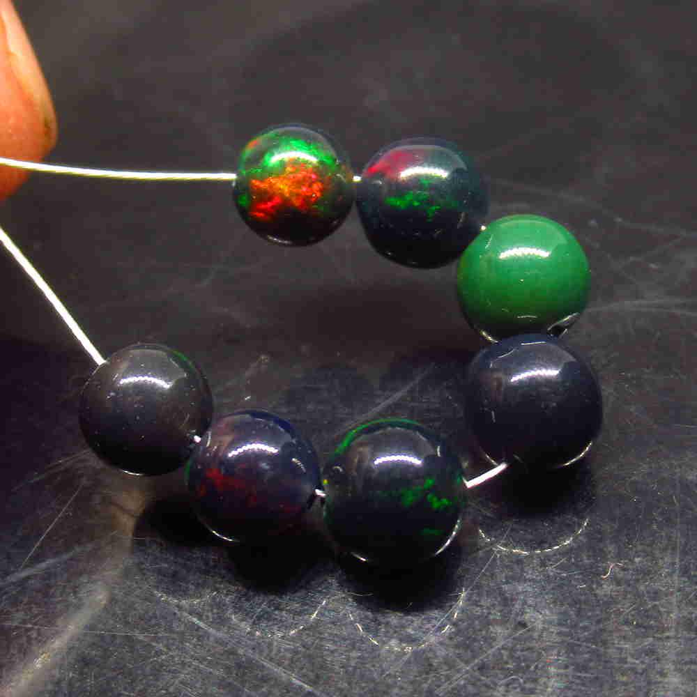5.50 Ctw Natural 7 Drilled Black Opal Ball Beads: No Reserve! Title: 5.50 Ctw Natural 7 Drilled Black Opal Ball Beads Stone Clarity: Translucent Gemstone: Black Opal Beads Carat Weight: 5.50 Size/Dimensions: 5.30 to 6.00 mm / 7 PC's Additional Inform