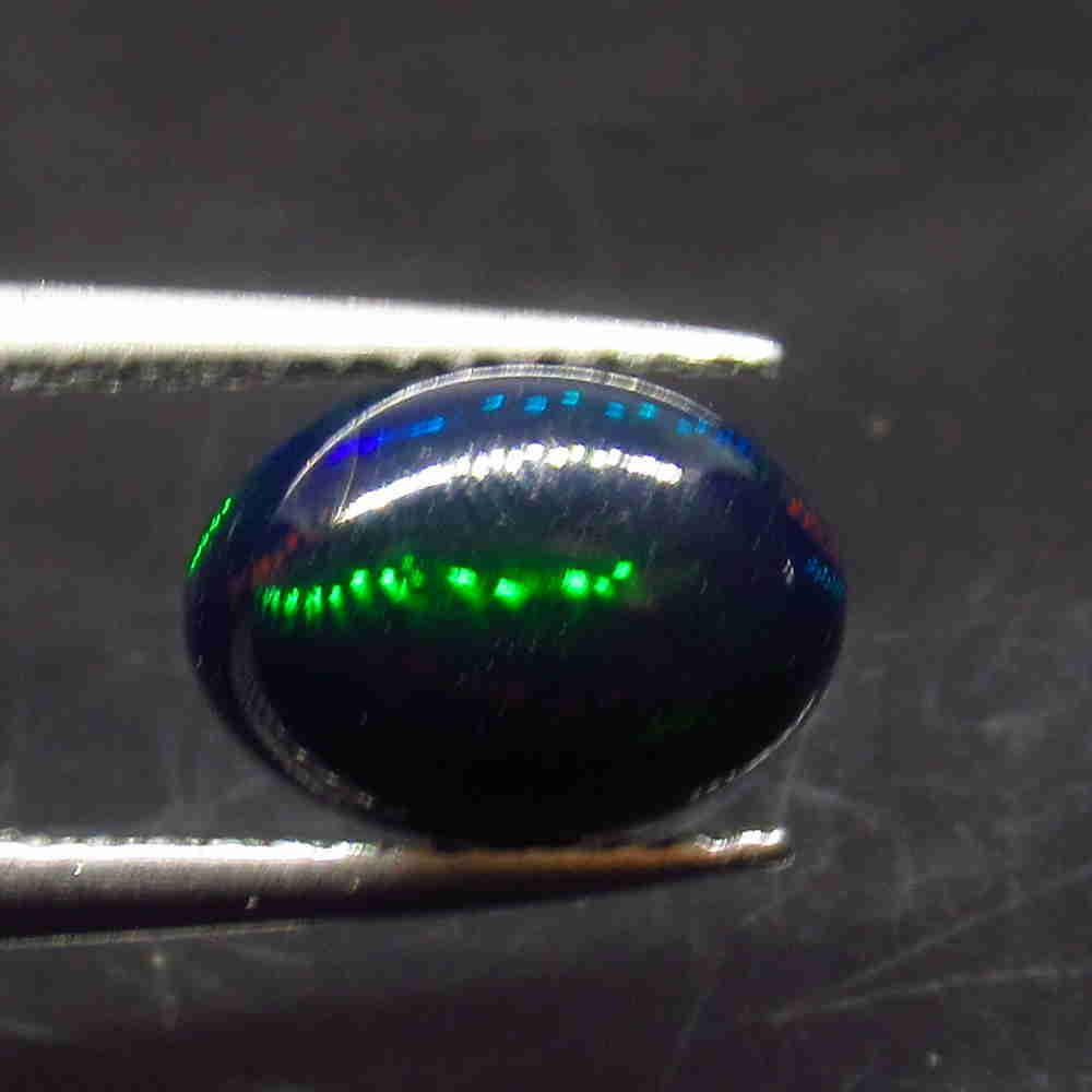 1.23 Ctw Natural Ethiopian Black Fire Opal Oval Cab: No Reserve! Title: 1.23 Ctw Natural Ethiopian Black Fire Opal Oval Cab Stone Clarity: Translucent Gemstone: Natural Black Opal Carat Weight: 1.23 Size/Dimensions: 9.20 x 6.60 x 4.50 mm Additional Info