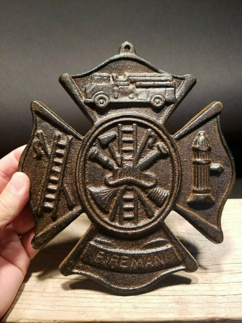 Cast Iron Rust Fire Fighter Plaque Fire Mark Sign: 9" Tall x 7 3/4" Wide Well made reproduction cast iron Fire Fighter Fireman plaque. Be sure to see the pictures.. looks old but is actually fairly new.. Reserve: $15.00 Shipping: Domestic: Flat-rate o