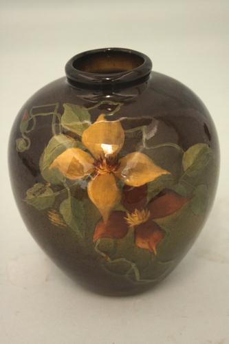 A squat dark standard glaze vase decorated with (1 of 5)