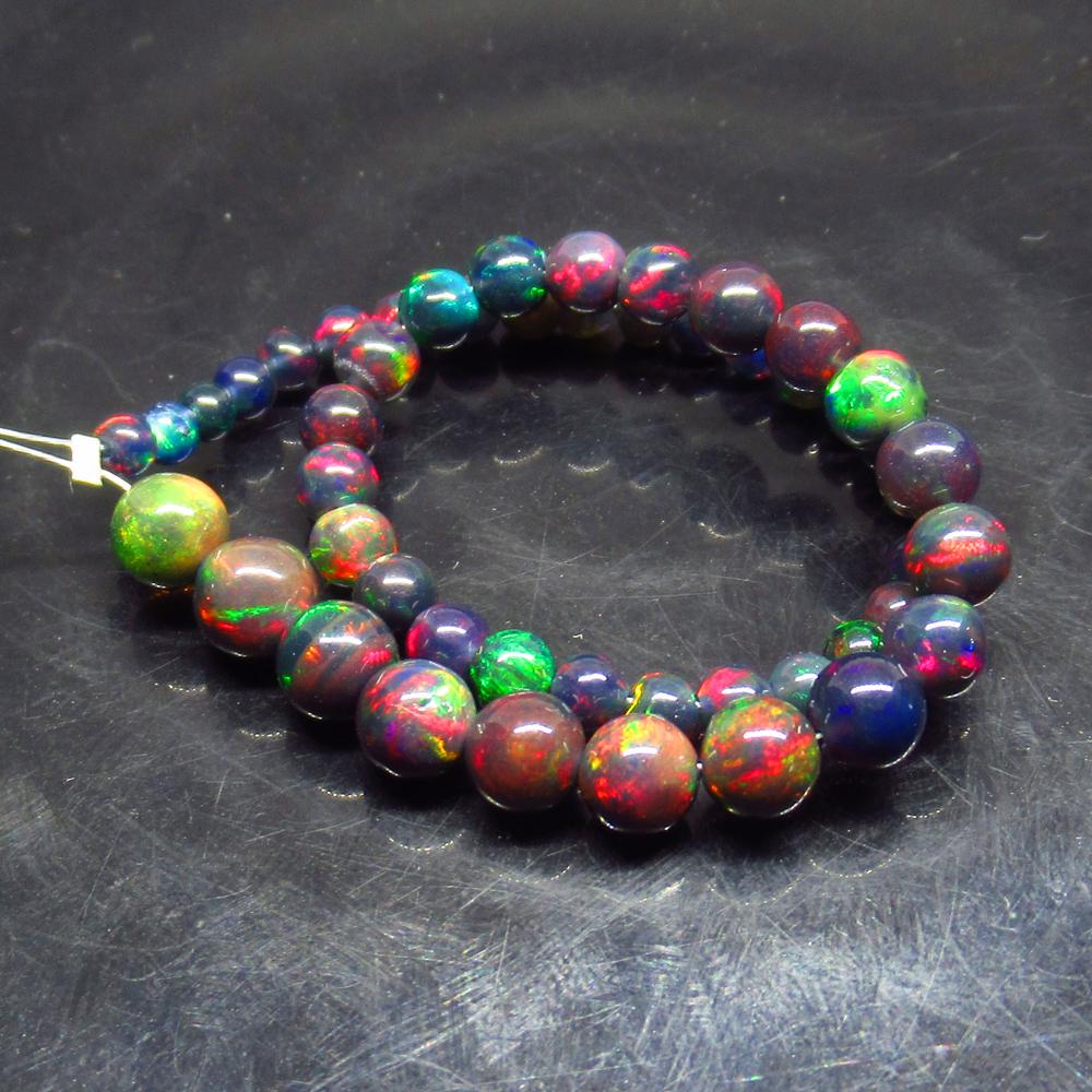 15.00 Ct Natural 49 Drilled Black Opal Ball Beads: Title: 15.00 Ct Natural 49 Drilled Black Opal Ball Beads Stone Clarity: Opaque Gemstones: Natural Black Opal Beads Carat Weights: 15 Size/Dimensions: 3.50 to 6.80 mm / 49 PC's Additional Information: 