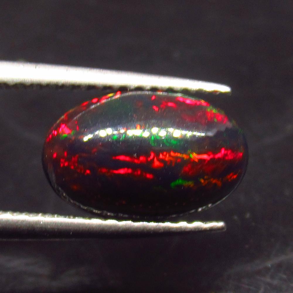 1.44 Ct Natural Ethiopian Black Fire Opal Oval Cab: Title: 1.44 Ct Natural Ethiopian Black Fire Opal Oval Cab Stone Clarity: Opaque Gemstones: Natural Black Opal Carat Weights: 1.44 Size/Dimensions: 11.10 x 7.30 x 4.00 mm Additional Information: Excell