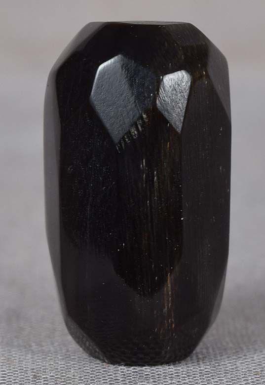 19c buffalo horn OJIME netsuke slide: Late Meiji - early Taisho (1910s) buffalo horn ojime (slide bead for tightening the cord going from netsuke to inro) in seed shape with faceted surface. Nice work, pleasant patina, good representative