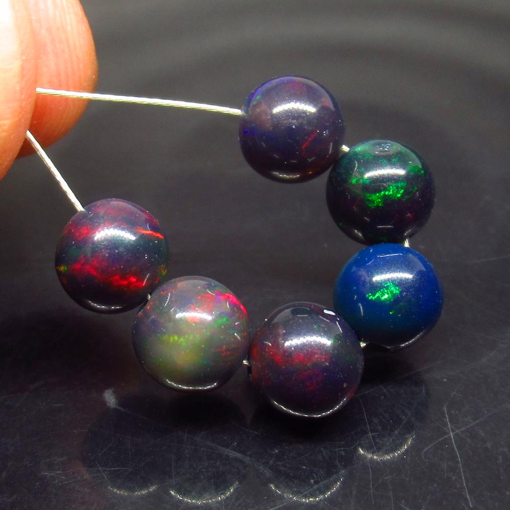 6.50 Ct Natural 6 Drilled Black Fire Opal Ball Beads: No Reserve! Title: 6.50 Ct Natural 6 Drilled Black Fire Opal Ball Beads Stone Clarity: Translucent Gemstone: Natural Black Opal Beads Carat Weight: 6.5 Size/Dimensions: 6.30 to 6.60 mm / 6 PC's Additi