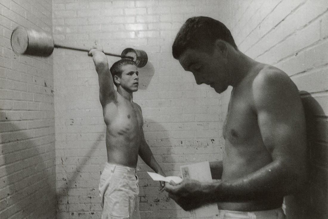 DANNY LYON - Weight Lifters, Ramsey Unit, TX, 1968: Artist: DANNY LYON Title: Weight Lifters, Ramsey Unit, Texas, 1968 Medium: Photo Litho, 1991, Germany Dimensions: 8.45x5.6" Description: Heat Wax Mounted on 8.5x11" Conservation Board Artist Bio: Dann