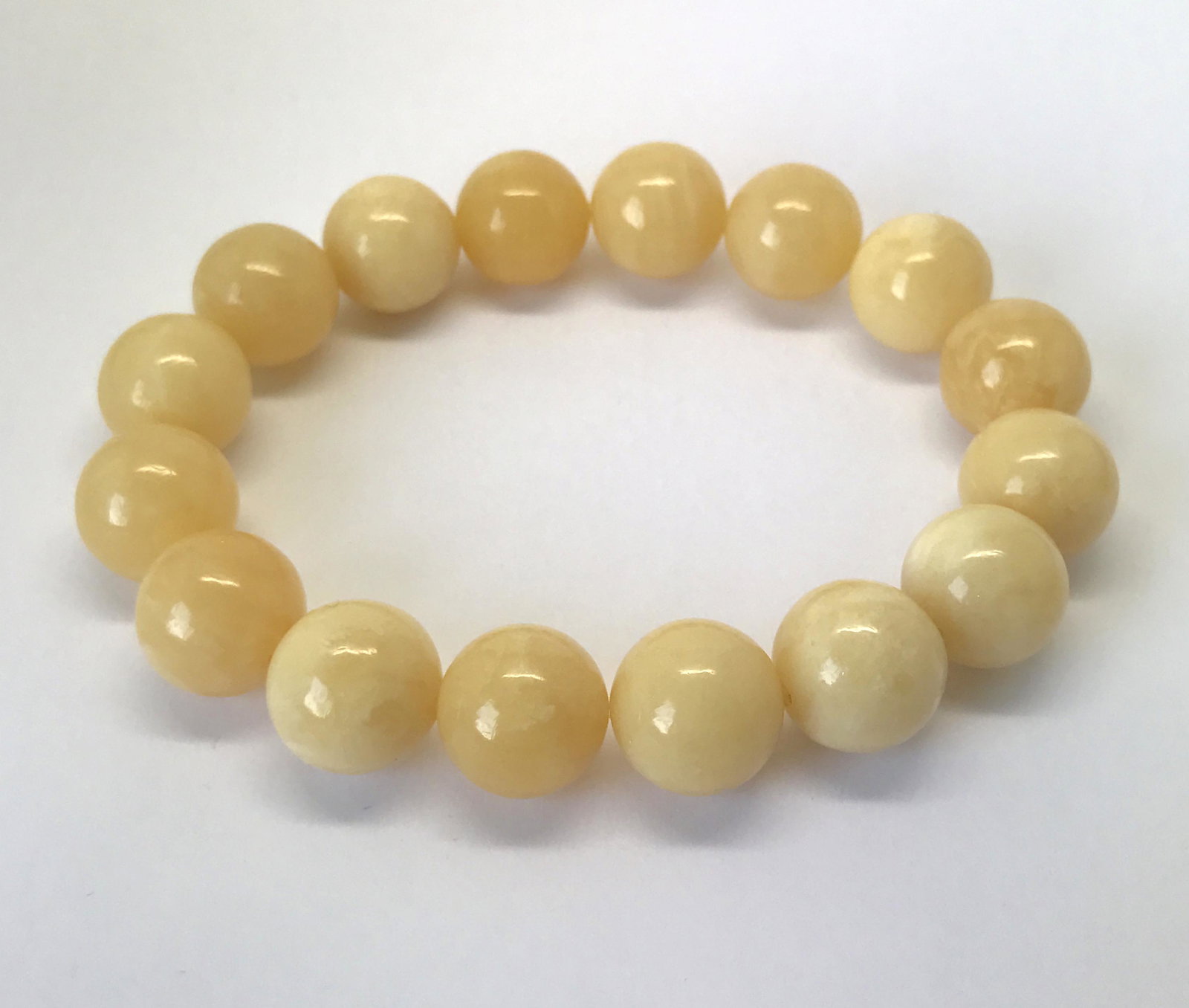 Phenomenal Amber Bracelet made from Round Amber beads: Title: Phenomenal Amber Bracelet made from Round Amber beads Metal: None Gemstones: Amber Weight: 17.1 g Size: Bead size: 12.0 mm Bead size: 0.472 inches Made of: Reconstituted Amber Additional Inform