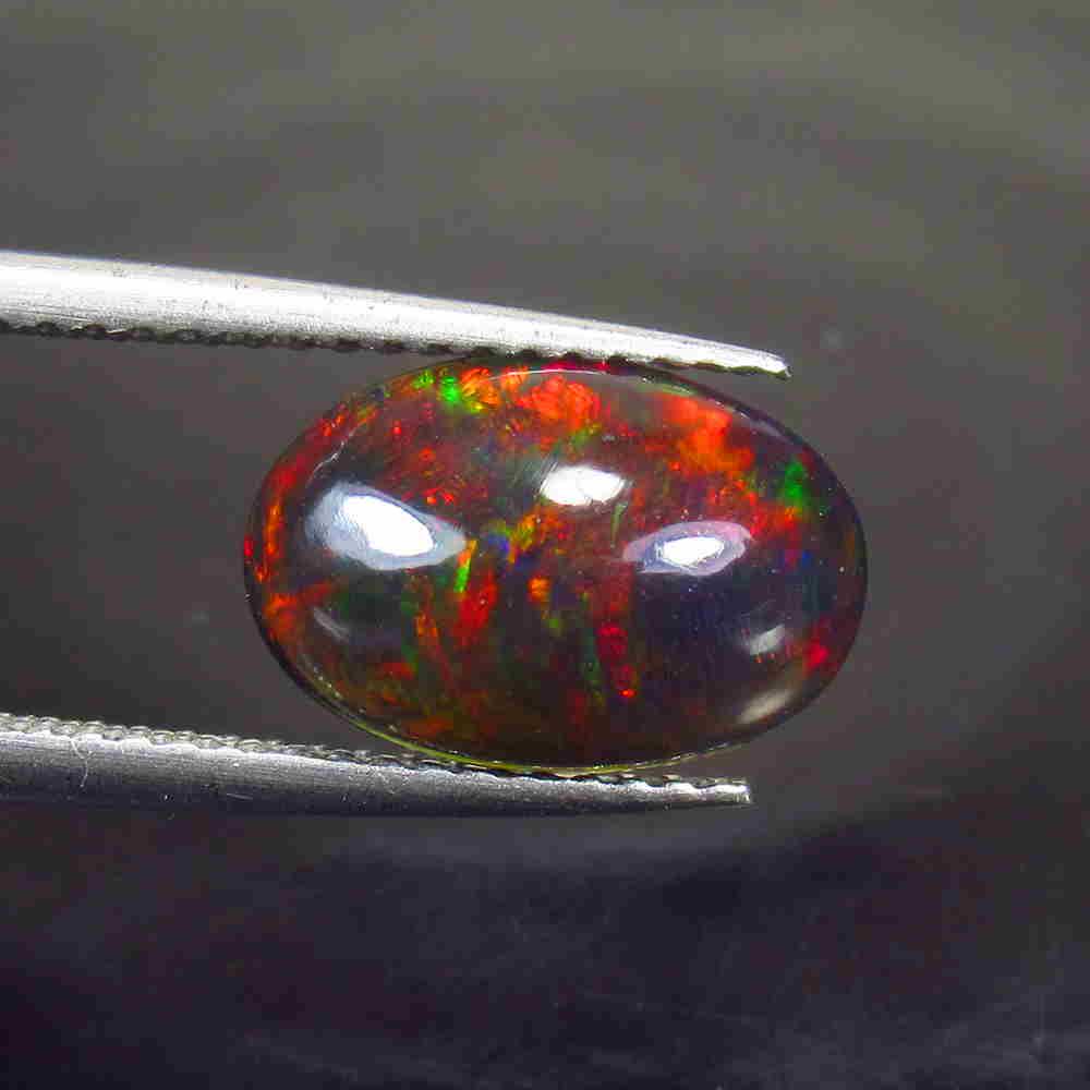 1.72 Ctw Natural Ethiopian Black Fire Opal Oval Cab: No Reserve! Title: 1.72 Ctw Natural Ethiopian Black Fire Opal Oval Cab Stone Clarity: Translucent Gemstone: Black Opal Carat Weight: 1.72 Size/Dimensions: 12.00 x 8.00 x 4.00 mm Additional Information