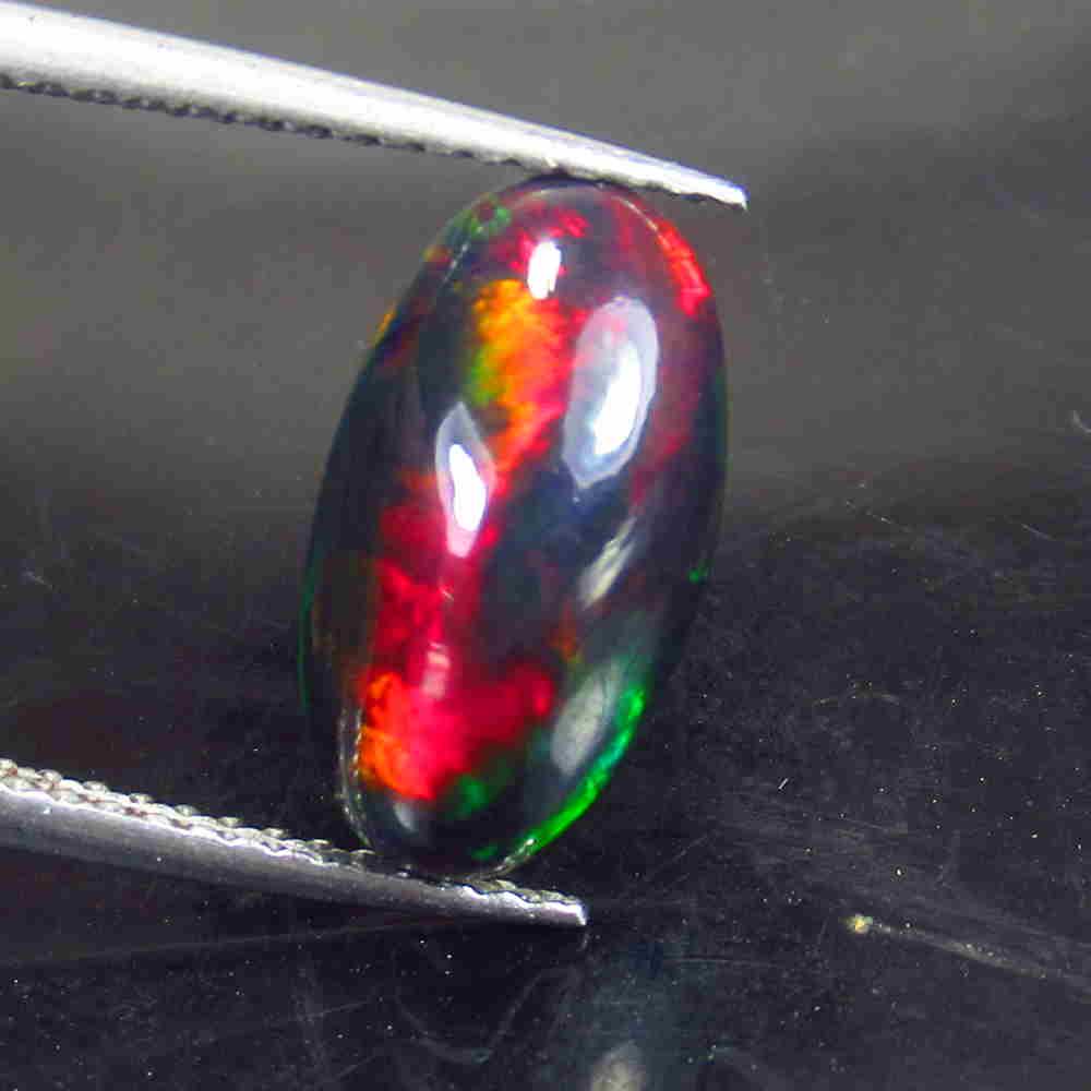 2.08 Ctw Natural Ethiopian Black Fire Opal Oval Cab: No Reserve! Title: 2.08 Ctw Natural Ethiopian Black Fire Opal Oval Cab Stone Clarity: Translucent Gemstone: Black Opal Carat Weight: 2.08 Size/Dimensions: 12.90 x 7.20 x 5.00 mm Additional Information