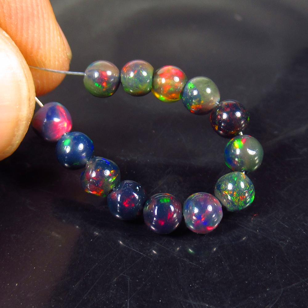 3.63 Ct Natural 14 Drilled Black Fire Opal Beads: No Reserve! Title: 3.63 Ct Natural 14 Drilled Black Fire Opal Beads Stone Clarity: Translucent Gemstone: Natural Black Opal Beads Carat Weight: 3.63 Dimensions: 3.80 to 4.30 mm / 14 PC's Additional In
