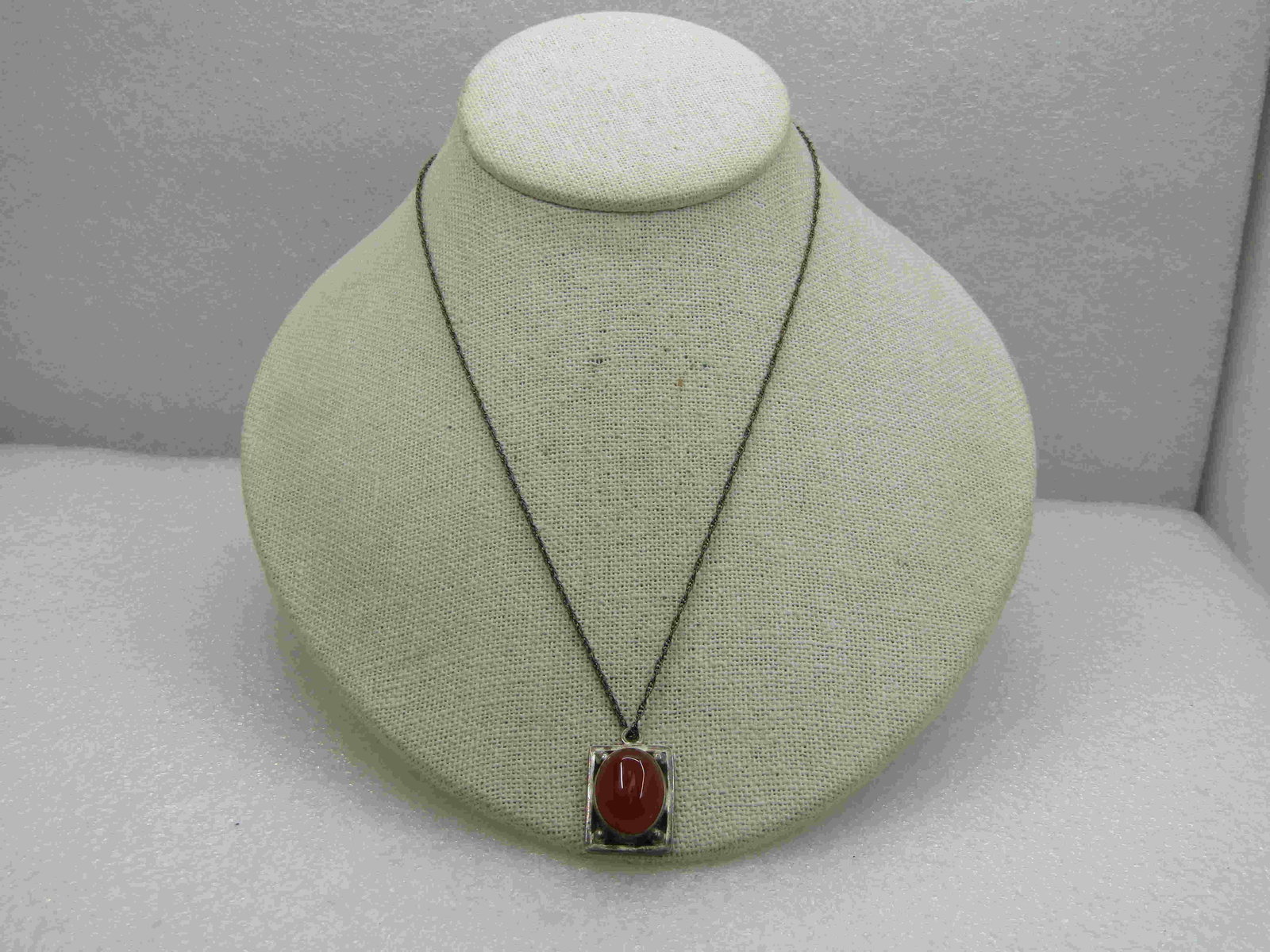 Vintage Sterling Southwestern Carnelian Necklace, 18": Vintage Sterling Southwestern Carnelian Necklace, 18". The pendant is appx. 1" long and 5/8" wide. The stone is appx. 15mm by 12mm, bezel-set. The stone is sitting on a framed rectangular base with be