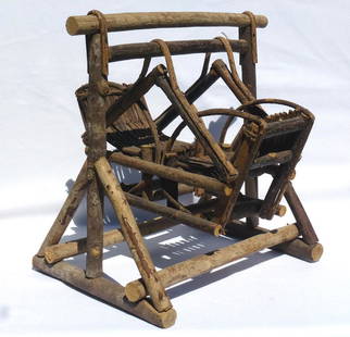 A rustic, miniature twig double swing or glider.: This is a rustic, miniature twig double swing or glider. It has good form and surface, with bent twigs for the seats and arms, and the swing mechanism. It stands 12 1/4" high by 11 1/2" wide by 12"