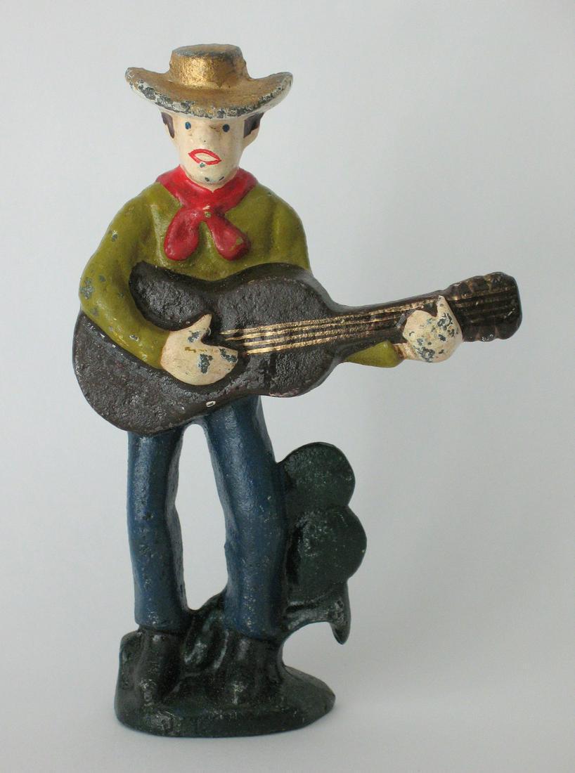 Vintage cast iron cowboy with guitar bottle opener. (1 of 2)