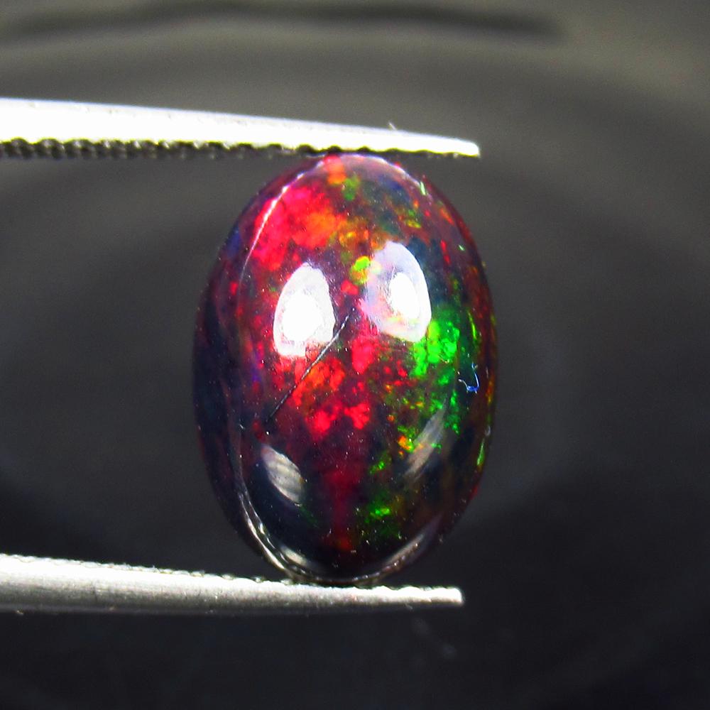 2.43 Ct Natural Ethiopian Black Fire Opal Oval Cab: No Reserve! Title: 2.43 Ct Natural Ethiopian Black Fire Opal Oval Cab Color/Clarity: Translucent Gemstone: Natural Black Opal Carat Weight: 2.43 Size/Dimensions: 12.60 x 8.70 x 5.00 mm Additional Info