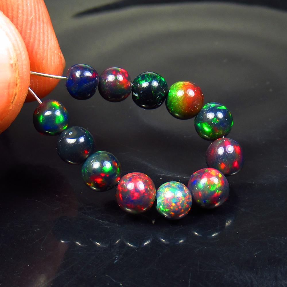 5.39 Ct Natural 12 Drilled Black Fire Opal Ball Beads: No Reserve! Title: 5.39 Ct Natural 12 Drilled Black Fire Opal Ball Beads Color/Clarity: Translucent Gemstone: Natural Black Opal Beads Carat Weight: 5.39 Size/Dimensions: 4.70 to 5.20 mm / 12 PC's Add