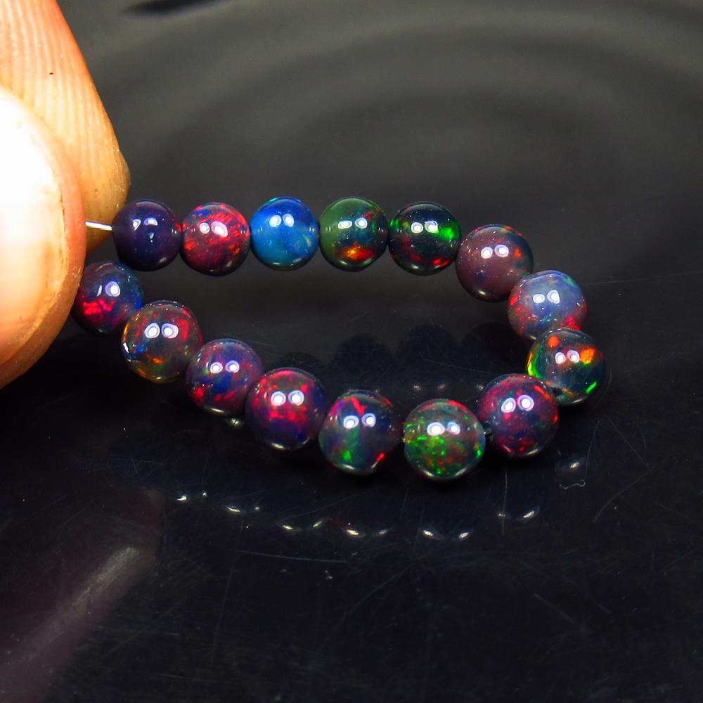 4.52 Ct Natural 15 Drilled Black Fire Opal Beads: No Reserve! Title: 4.52 Ct Natural 15 Drilled Black Fire Opal Beads Color/Clarity: Translucent Gemstone: Natural Black Opal Beads Carat Weight: 4.52 Size/Dimensions: 4.30 to 4.50 mm / 15 PC's Addition