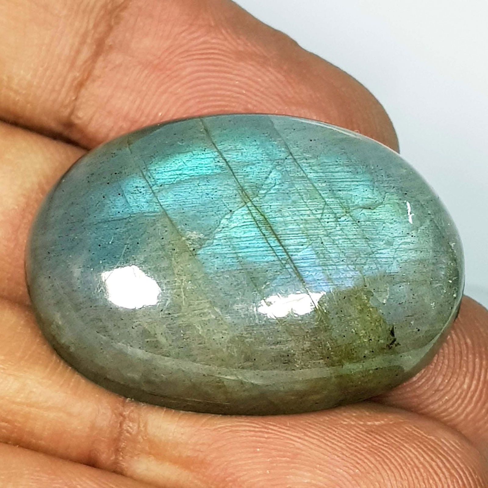 61.07 Ct Natural Labradorite: No Reserve! Title: 61.07 Ct Natural Labradorite Color/Clarity: Opaque Carat Weight: 61.07 Dimensions: 31.40 x 22.80 x 10.30 Additional Information: Oval - USA Shipping: Domestic: Flat-rate of $7.0
