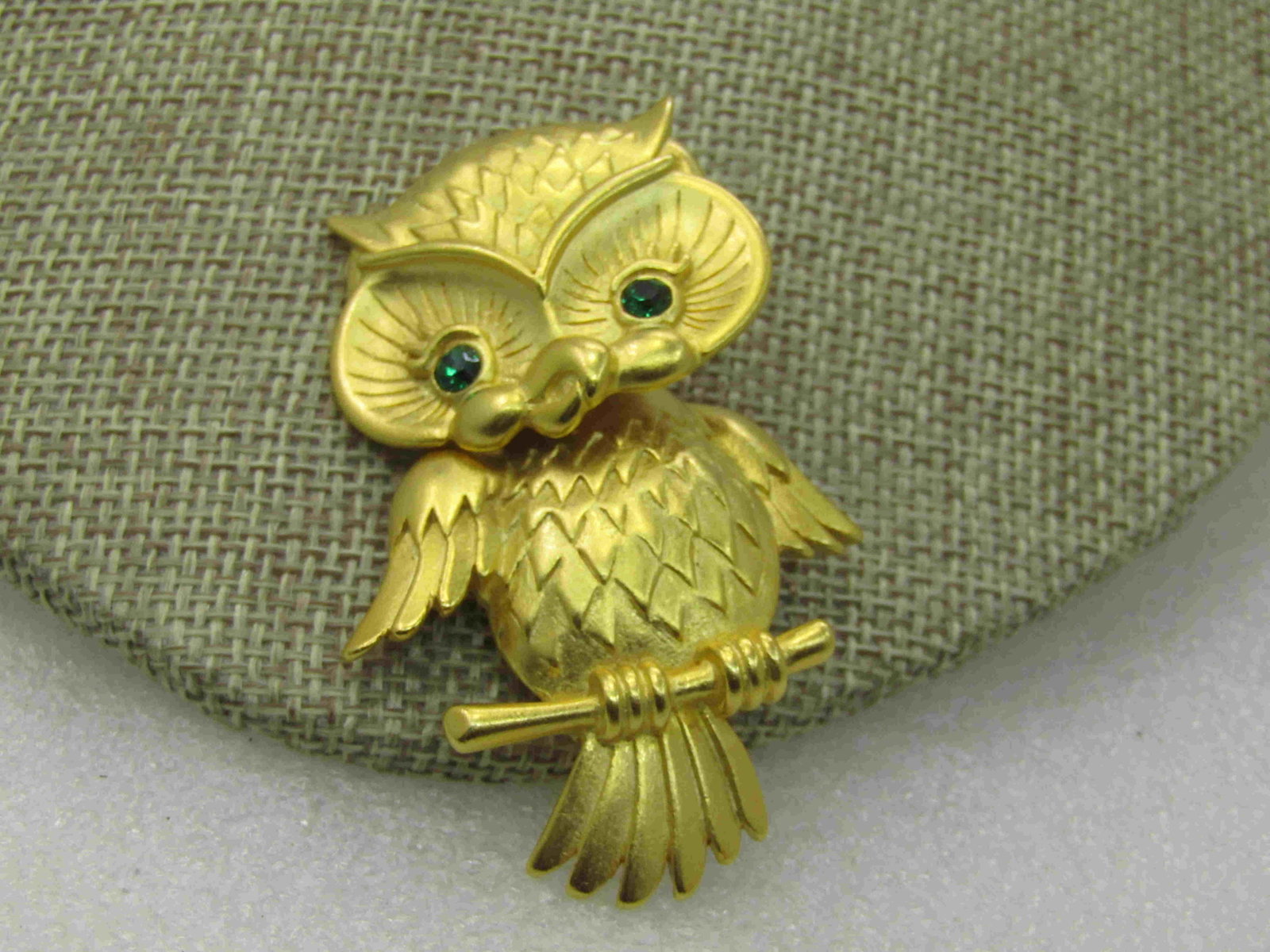 Vintage Articulated Owl Brooch, signed JJ, 2.25": Vintage Articulated Owl Brooch, signed JJ, 2.25" by 1.25", gold tone, satin finish with green rhinestone eyes. 1980's. Nice large brooch, cute detail and great for the owl collector. The body swings f
