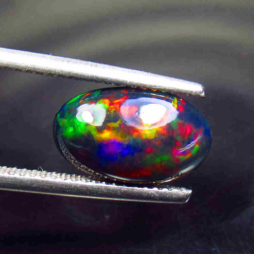 2.54 Ctw Natural Ethiopian Black Fire Opal Oval Cab: Title: 2.54 Ctw Natural Ethiopian Black Fire Opal Oval Cab Stone Clarity: Translucent Gemstones: Black Opal Size/Dimensions: 2.54 Carat Weights: 13.60 x 8.30 x 4.90 mm Additional Information: Excellen