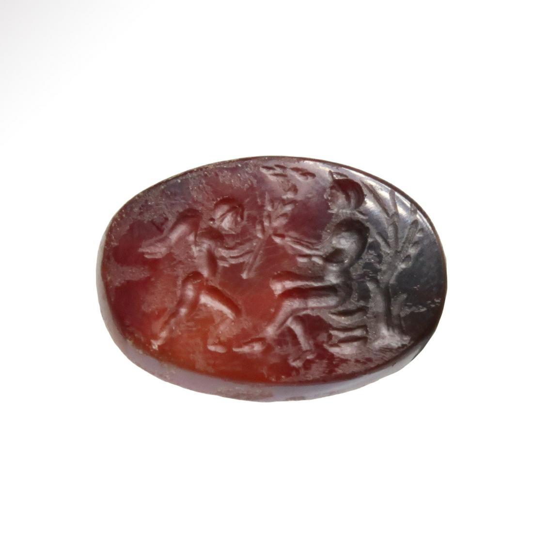 Roman Cornelian Intaglio with Cupid and Psyche: Title: Roman Cornelian Intaglio with Cupid and Psyche Date & Origin: Roman, 1st-2nd Century A.D. Description: Roman dark red cornelian showing winged Eros, offering a long stemmed flower to Psyche whi