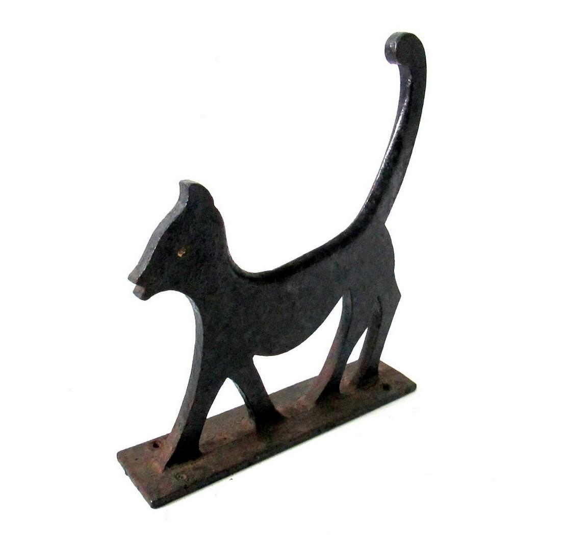Strutting Cat Boot Scraper: Title: Strutting Cat Boot Scraper Date/Period: C 1900 Materials: Cast Iron Dimension: 12 1/8” X 10 3/8”W X 2 1/2”D Additional Information: Bold silhouette form, a black cat with “attitude”.