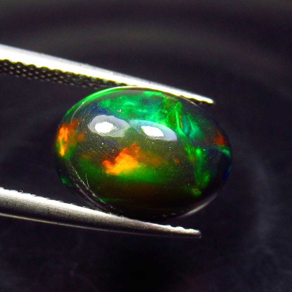 3.50 Ctw Natural Ethiopian Black Fire Opal Oval Cab: No Reserve! Title: 3.50 Ctw Natural Ethiopian Black Fire Opal Oval Cab Stone Clarity: Translucent Gemstone: Black Opal Carat Weight: 3.5 Size/Dimensions: 12.20 x 9.20 x 6.20 mm Additional Information: