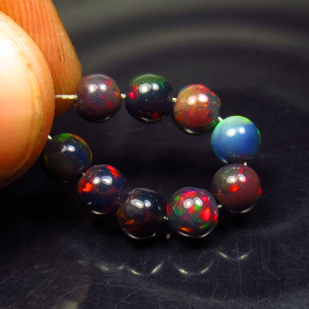 4.47 Ctw Natural 9 Drilled Black Fire Opal Ball Beads: No Reserve! Title: 4.47 Ctw Natural 9 Drilled Black Fire Opal Ball Beads Stone Clarity: Transparent Gemstone: Black Opal Beads Carat Weight: 4.47 Size/Dimensions: 4.80 to 5.10 mm / 9 PC's Additional I