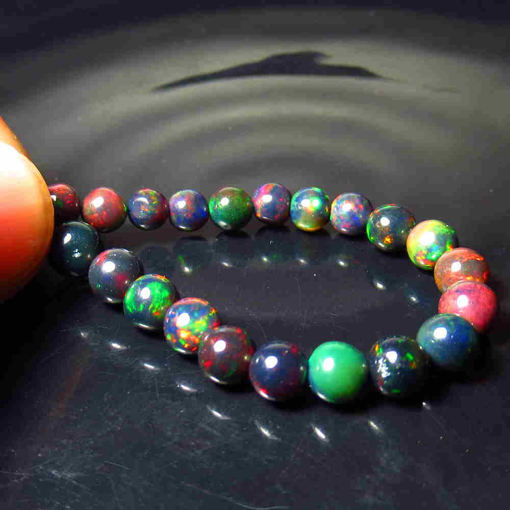 13.56 Ctw Natural 21 Drilled Black Fire Opal Ball Beads: Title: 13.56 Ctw Natural 21 Drilled Black Fire Opal Ball Beads Stone Clarity: Translucent Gemstones: Black Opal Beads Size/Dimensions: 13.56 Carat Weights: 4.50 to 6.00 mm / 21 PC's Additional Informa