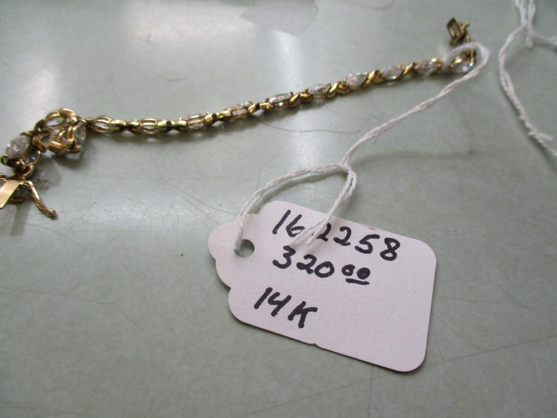 10kt Marquise CZ Tennis Bracelet, 7.75", 9.06 Gr.: 10kt Marquise CZ X Tennis Bracelet, 7.75", 9.06 Gr. Signed OR, CZ and marked 10kt and tested. Yellow Gold. 15 marquise CZs that are appx. 7.5mm by 3.5mm, very cleark. Each stone is appx. .25 ctw for a