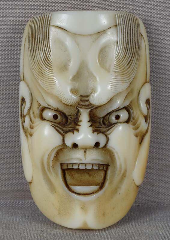 19c marine MASK netsuke HEAVENLY GENERAL: 19th century marine material netsuke representing a theater mask of a fierce deity with amazingly bushy eyebrows. I believe the character is one of the 12 Heavenly Generals, not sure which one. Superb