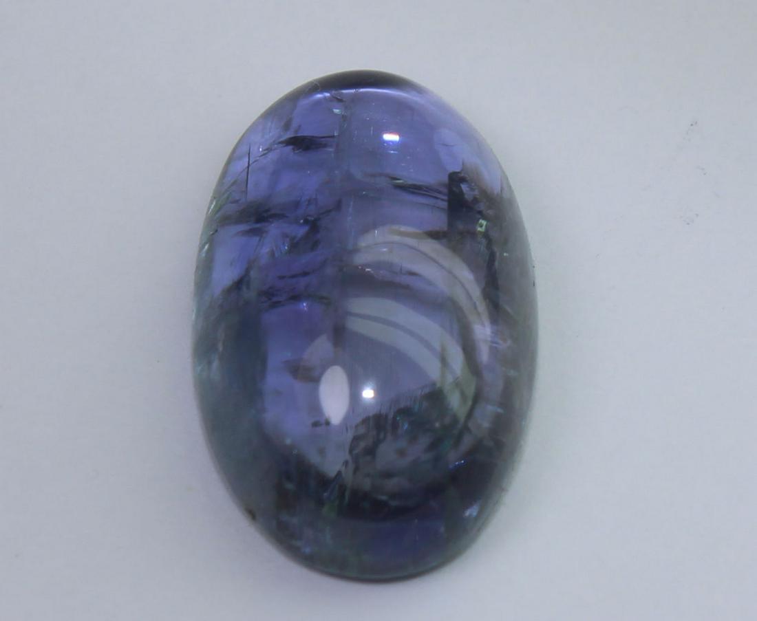 9.60 Cts Natural Tanzanite: No Reserve! Title: 9.60 Cts Natural Tanzanite Additional Information: Gemstone : Natural Tanzanite Origin : Tanzania Weight : 9.60 carats Dimensions : 16.2x10.1x5.9 mm Shape : Oval Cabochon Color : Vi