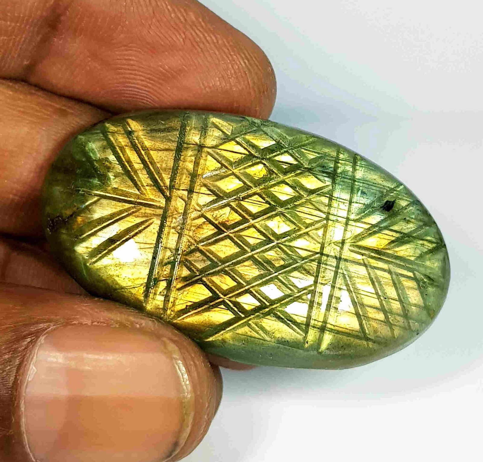 64.82 Ct Natural Labradorite Oval Designer cut: No Reserve! Title: 64.82 Ct Natural Labradorite Oval Designer cut Color/Clarity: Opaque Carat Weight: 64.82 Size/Dimensions: 41.40 x 24.60 x 7.50 Additional Information: Oval - USA Shipping: Domes