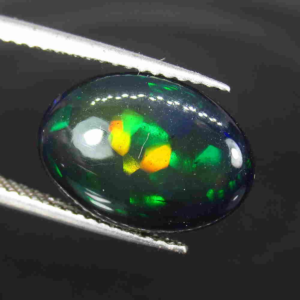 4.85 Ctw Natural Ethiopian Black Fire Opal Oval Cab: No Reserve! Title: 4.85 Ctw Natural Ethiopian Black Fire Opal Oval Cab Stone Clarity: Transparent Gemstone: Black Opal Carat Weight: 4.85 Size/Dimensions: 14.00 x 10.10 x 6.00 mm Additional Informatio