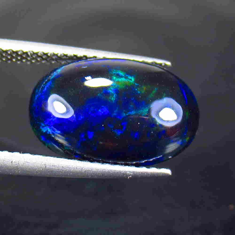 4.30 Ctw Natural Ethiopian Black Fire Opal Oval Cab: No Reserve! Title: 4.30 Ctw Natural Ethiopian Black Fire Opal Oval Cab Stone Clarity: Translucent Gemstone: Black Opal Carat Weight: 4.3 Size/Dimensions: 14.60 x 9.80 x 5.80 mm Additional Information: