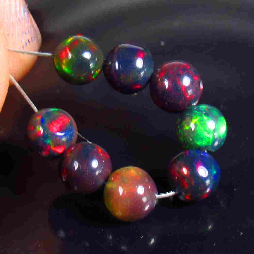 4.86 Ctw Natural 8 Drilled Black Opal Ball Beads: No Reserve! Title: 4.86 Ctw Natural 8 Drilled Black Opal Ball Beads Stone Clarity: Translucent Gemstone: Black Opal Beads Carat Weight: 4.86 Size/Dimensions: 5.10 to 5.40 mm / 8 PC's Additional Inform