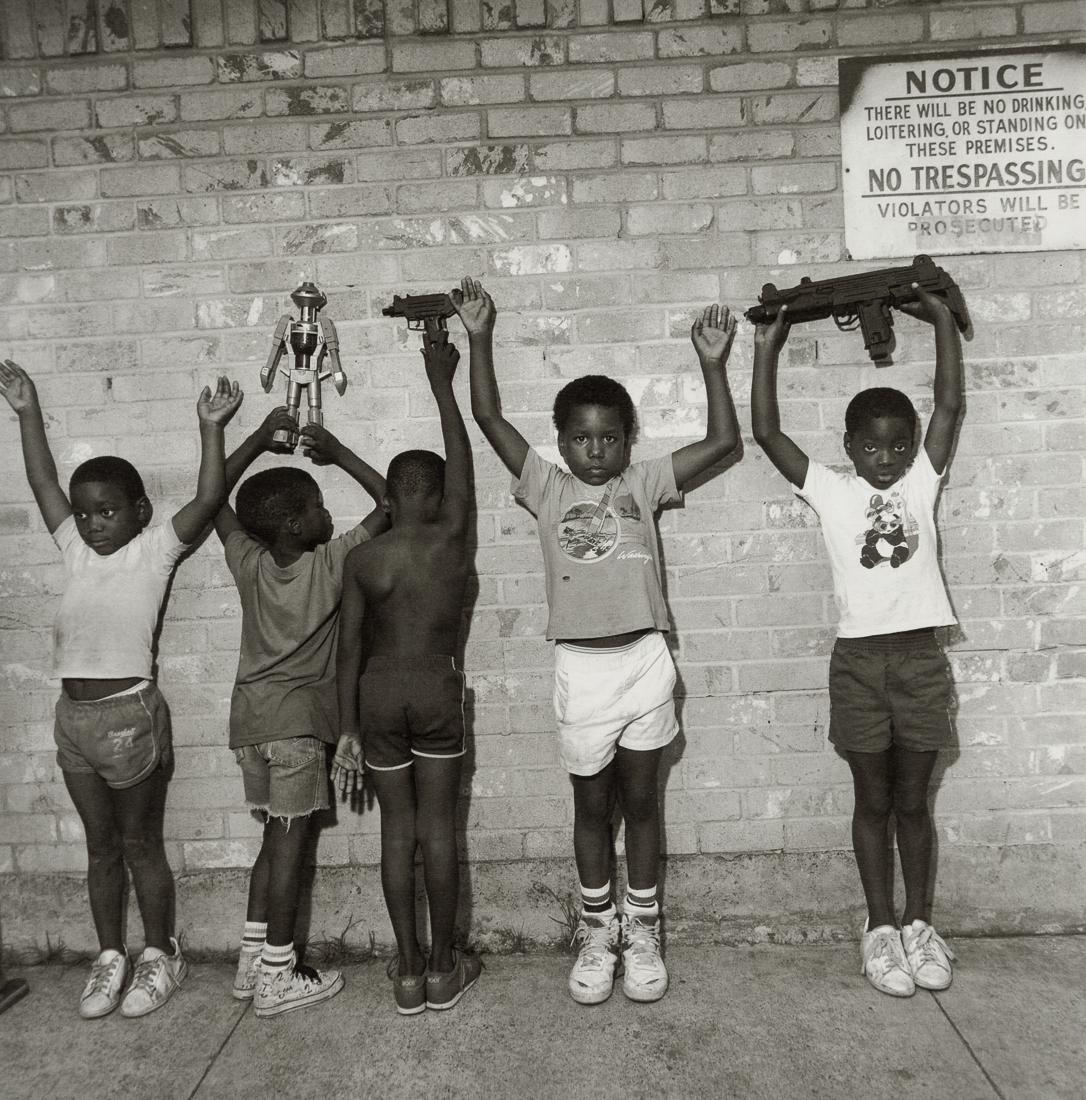 MARY ELLEN MARK - Children Playing Gangsters, 1988: Artist: Mary Ellen Mark Title: Children Playing Gangsters, South Dallas, Texas, 1988 Medium: Photo Litho, 1999, Italy Dimensions: 8x8.1" Description: Heat Wax Mounted on 11x14" Conservation Board Arti