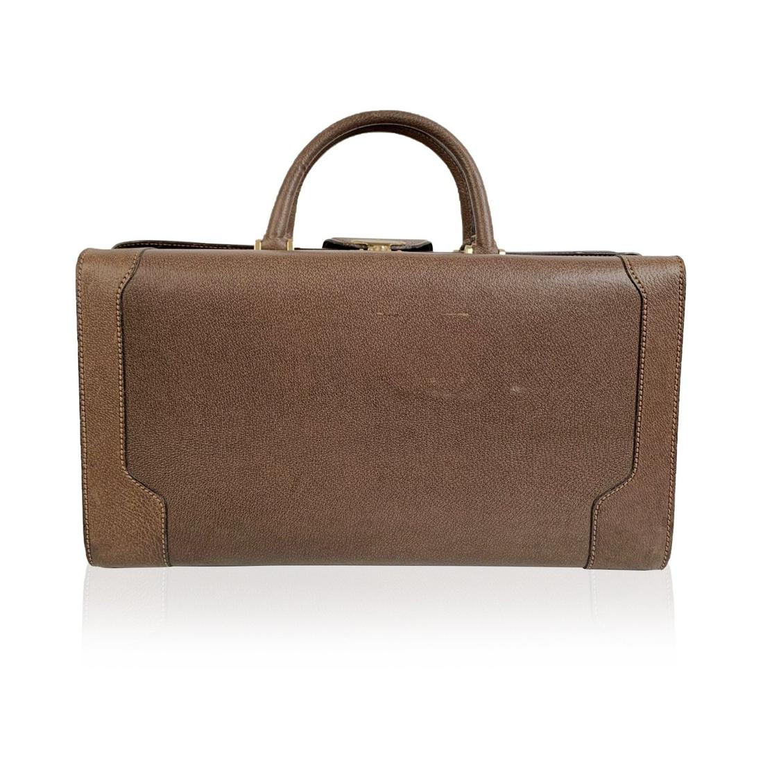 Gucci Vintage Tan Leather Travel Bag Weekend Overnight: Splendid vintage travel weekend bag by GUCCI from the early 1970s. With gold metal hardware. It features an upper lock and snap closure + security key closure on sides (keys are not included). Double