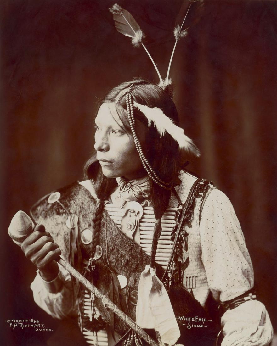 1899_WHITE FACE – SIOUX, HOLDING A LONG HANDLED WAR (1 of 1)