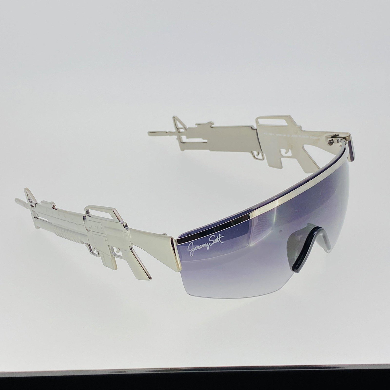 Jeremy Scott Sunglasses Shield Gun Metal and Purple: Jeremy Scott Collection Special Edition Frame/Temple Colour: Gun Metal Frame/Temple Material: Gun Metal Size 137-142 Model No: JSM16C2SUN Nylon Category 1 Light Tint Lenses - Purple Graduated Ma