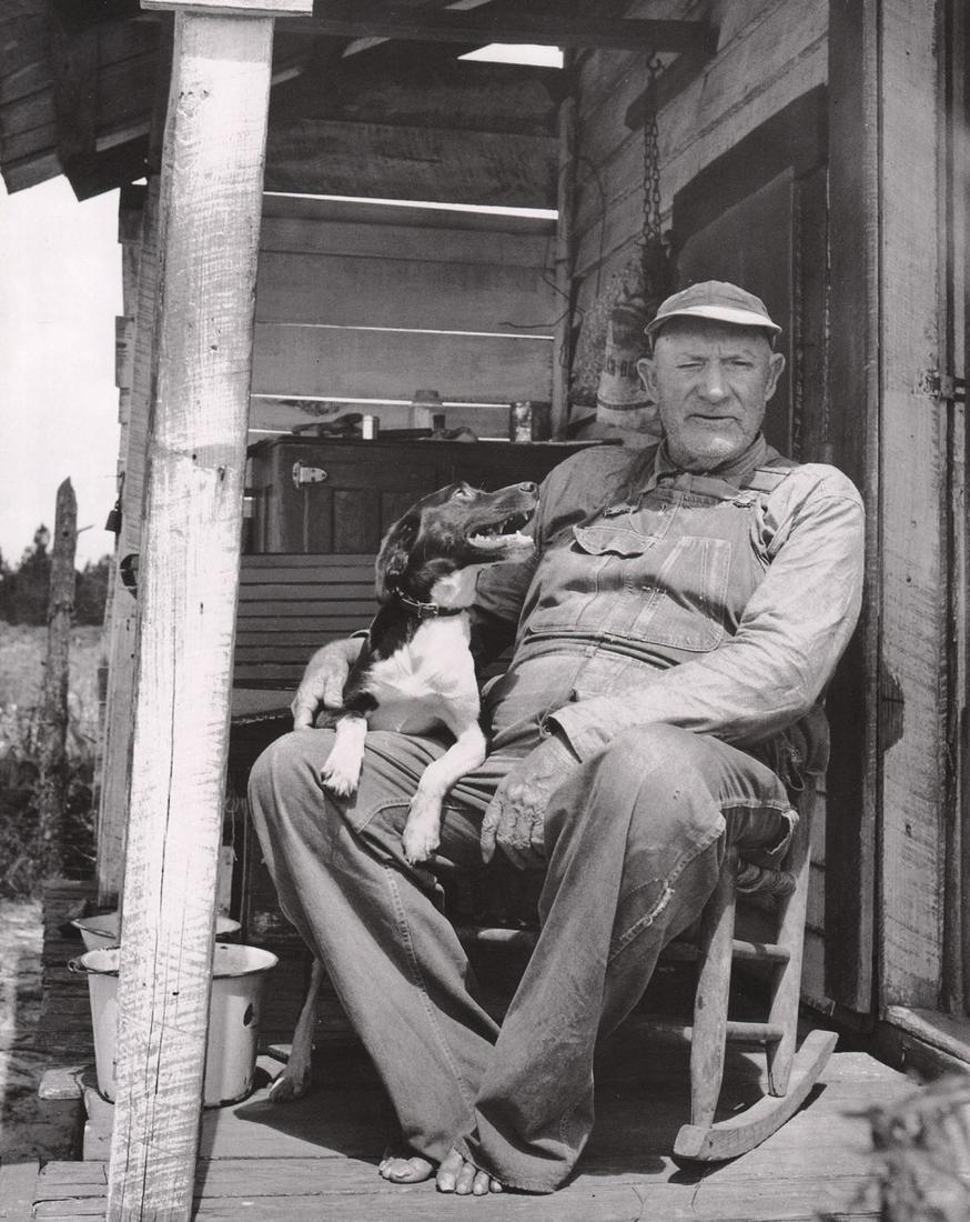 BERENICE ABBOTT - Old Man on Porch with dog: Artist: BERENICE ABBOT Print Title: Old Man on Porch with dog Medium: Photo-lithograph Printed in: Japan, 1982 Image Size: approx. 11 x 9” Berenice Abbott (1898 – 1991),was an American photographe