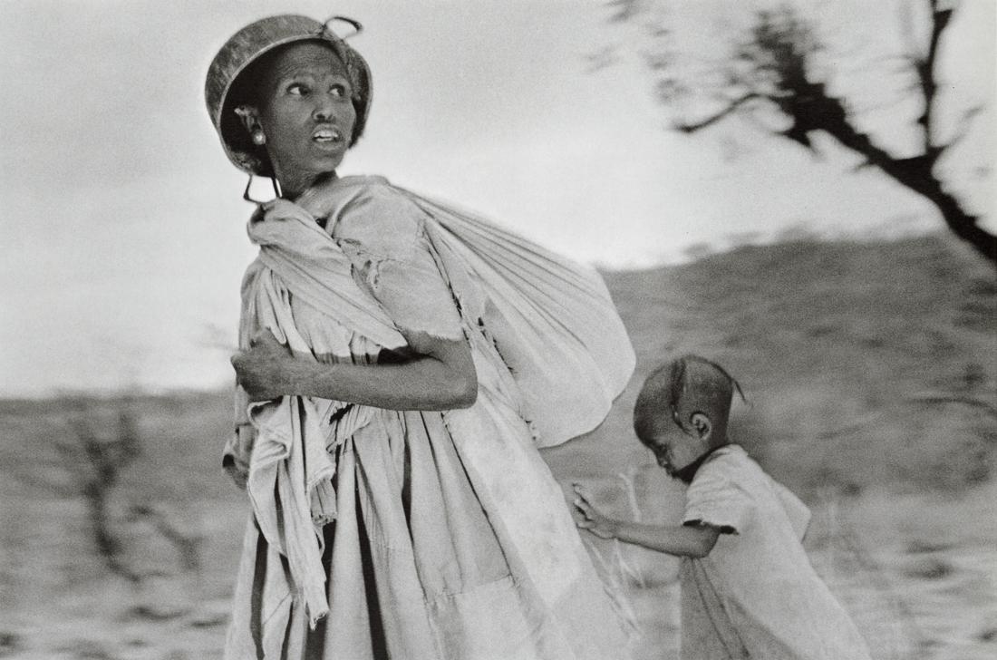 SEBASTIAO SALGADO - Women Try to Escape, Ethiopia: Artist: Sebastiao Salgado Title: Women Scout for Airplanes Trying to Escape to Sudan, Tigre, Ethiopia, 1985 Medium: Photo Litho, 1999, Italy Dimensions:9.6x6.35" Description: Heat Wax Mounted on 11x14