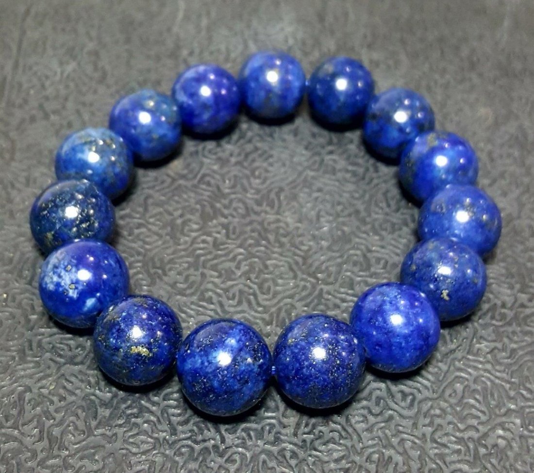 Lapis Lazuli Bracelet - 14 mm Beads Size: Title: Lapis Lazuli Bracelet - 14 mm Beads Size Origin: Afghanistan Reserve: $90.00 Shipping: Domestic: Flat-rate of $23.00 to anywhere within the contiguous U.S. International: Foreign shipping rates