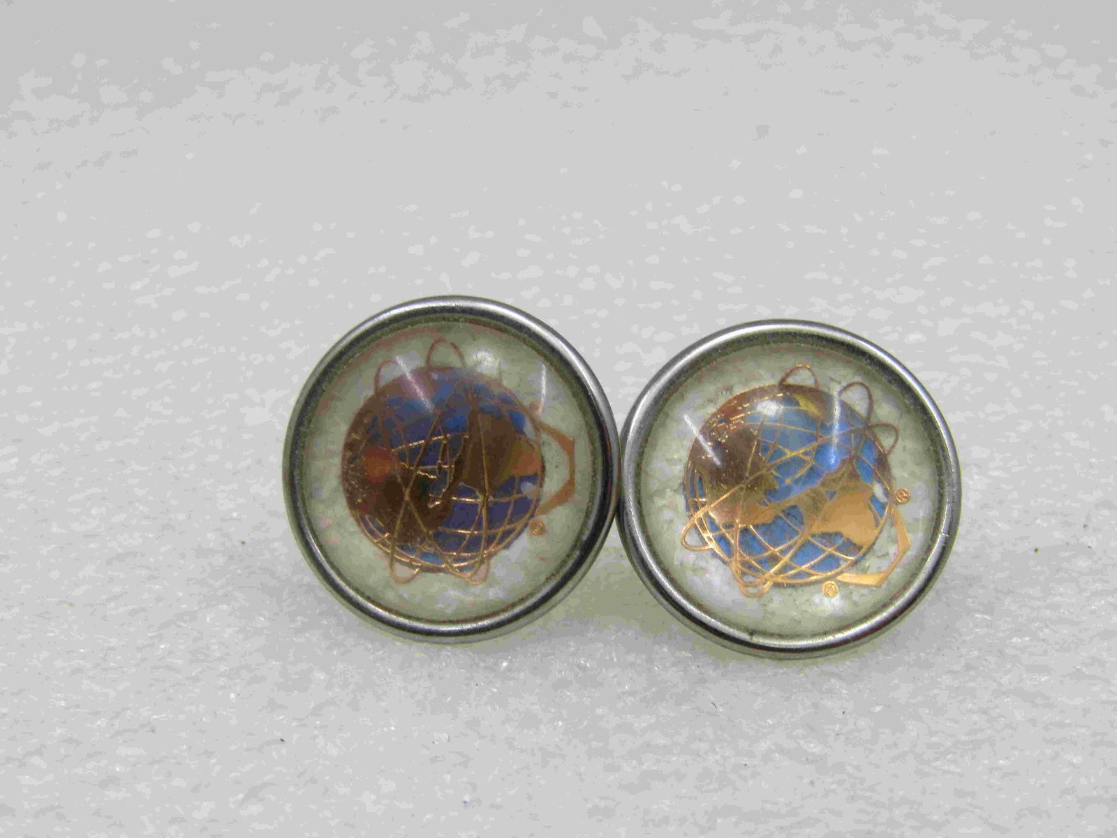 1961 World's Fair Morpho Atlas Earrings by Hoffman,: 1961 World's Fair Morpho Atlas Earrings by Hoffman, Screw Back, 1960's, Original Card, 7/8" round with domed clear acrylic covering. Silver tone. Butterfly wing under the gold Atlas and white backgrou