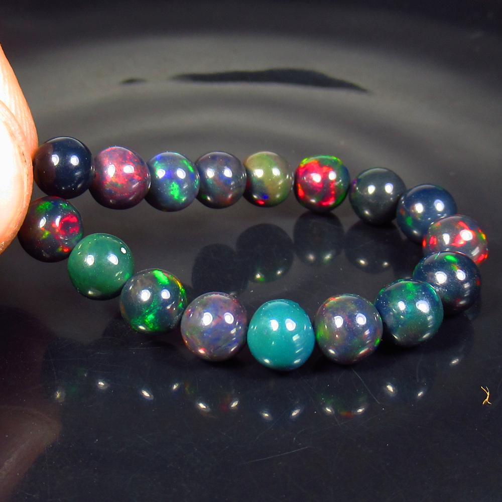 15.29 Ctw Natural 17 Drilled Black Fire Opal Ball Beads: Title: 15.29 Ctw Natural 17 Drilled Black Fire Opal Ball Beads Stone Clarity: Translucent Gemstones: Black Opal Beads Carat Weights: 15.29 Size/Dimensions: 5.60 to 6.10 mm / 17 PC's Additional Informa