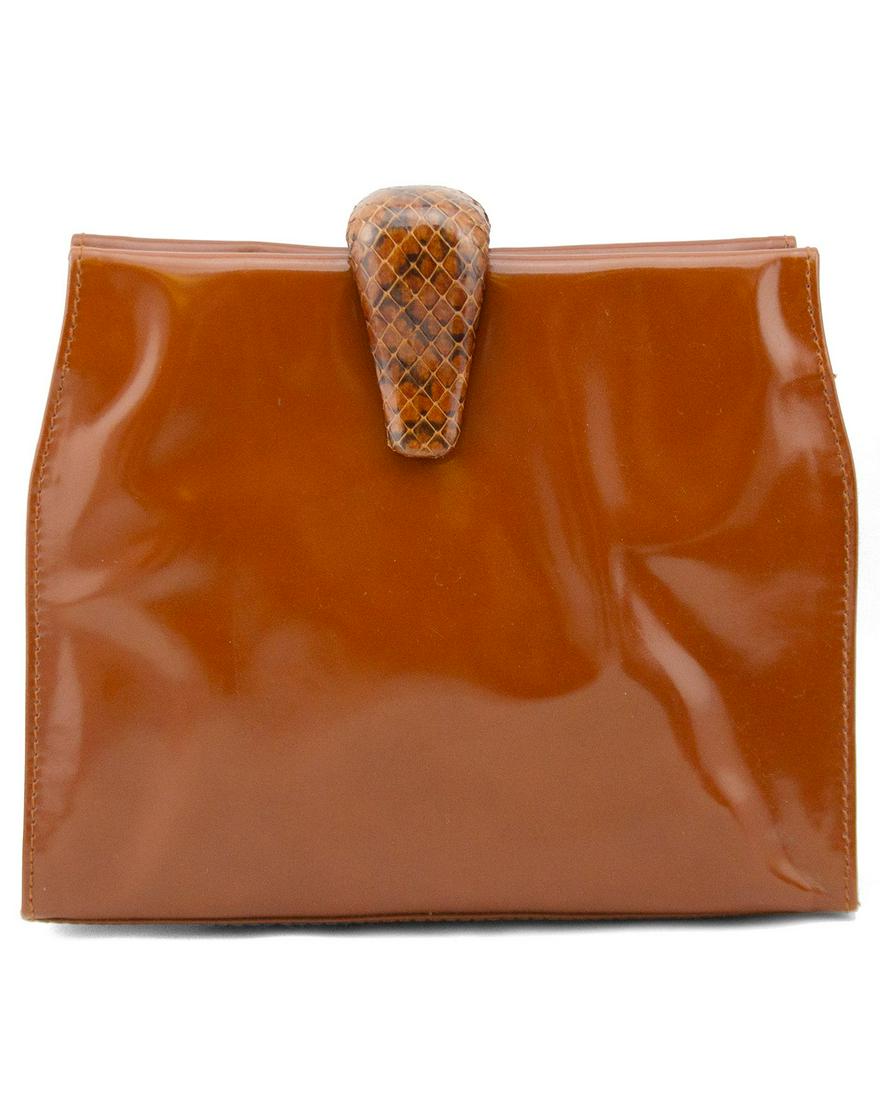 Prada Terracotta Patent Leather Clutch: Very cool, minimal Prada clutch from the 1990s. Terracotta coloured patent leather with matching terracotta and black exotic pattern clasp closure. Zipper closure across top. Prada brand stamp on left
