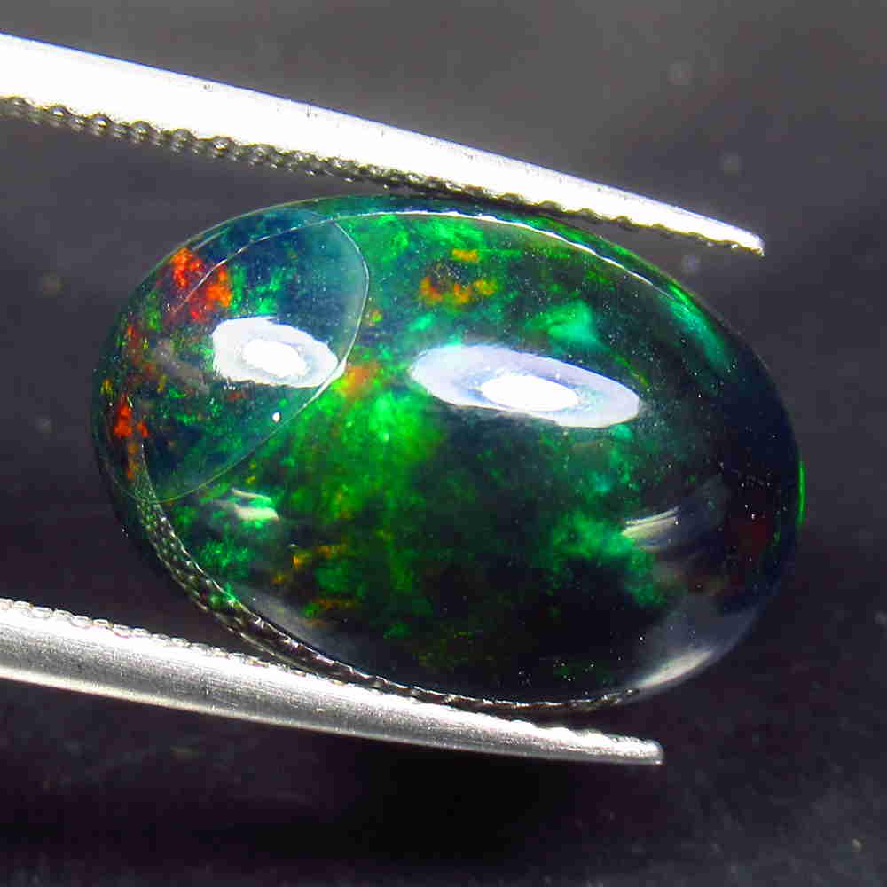 5.60 Ctw Natural Ethiopian Black Fire Opal Oval Cab: No Reserve! Title: 5.60 Ctw Natural Ethiopian Black Fire Opal Oval Cab Stone Clarity: Translucent Gemstone: Black Opal Carat Weight: 5.6 Size/Dimensions: 16.30 x 11.10 x 6.60 mm Additional Information