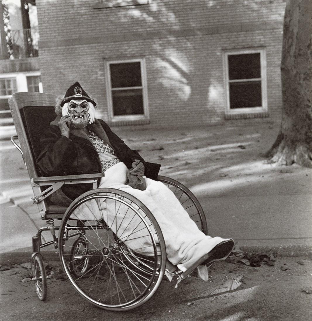 DIANE ARBUS - Masked Woman in a Wheelchair, PA, 1970: Artist: Diane Arbus Title: Masked Woman in a Wheelchair, PA, 1970 Medium: Photo Litho, 1972, USA Dimensions: 8.2x8.45" Description: Heat Wax Mounted on 11x14" Conservation Board Artist Bio: Diane Arbu