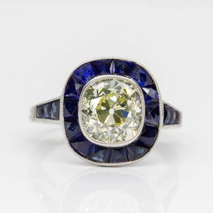 Handmade Art Deco Inspired Antique Old Mine Cushion: Absolutely eye-catching ring with one central old mine cushion cut diamond of K-L/VS1 quality that weighs 2.69ctw. Handmade in platinum, the exquisite diamond is surrounded by a halo of 14 natural